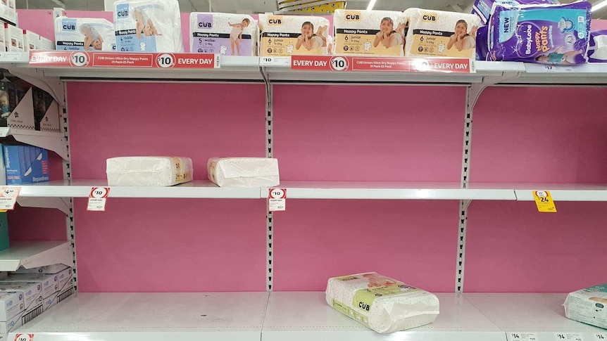 A row on pink shelves is largely empty, with few nappies left.