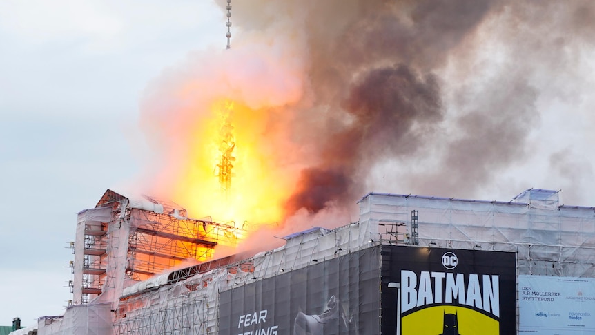 A fire engulfs the building's spire.