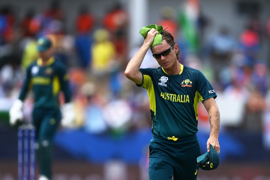 Australia bowler Adam Zampa wipes his head with a towel after losing a T20 World Cup game against India.
