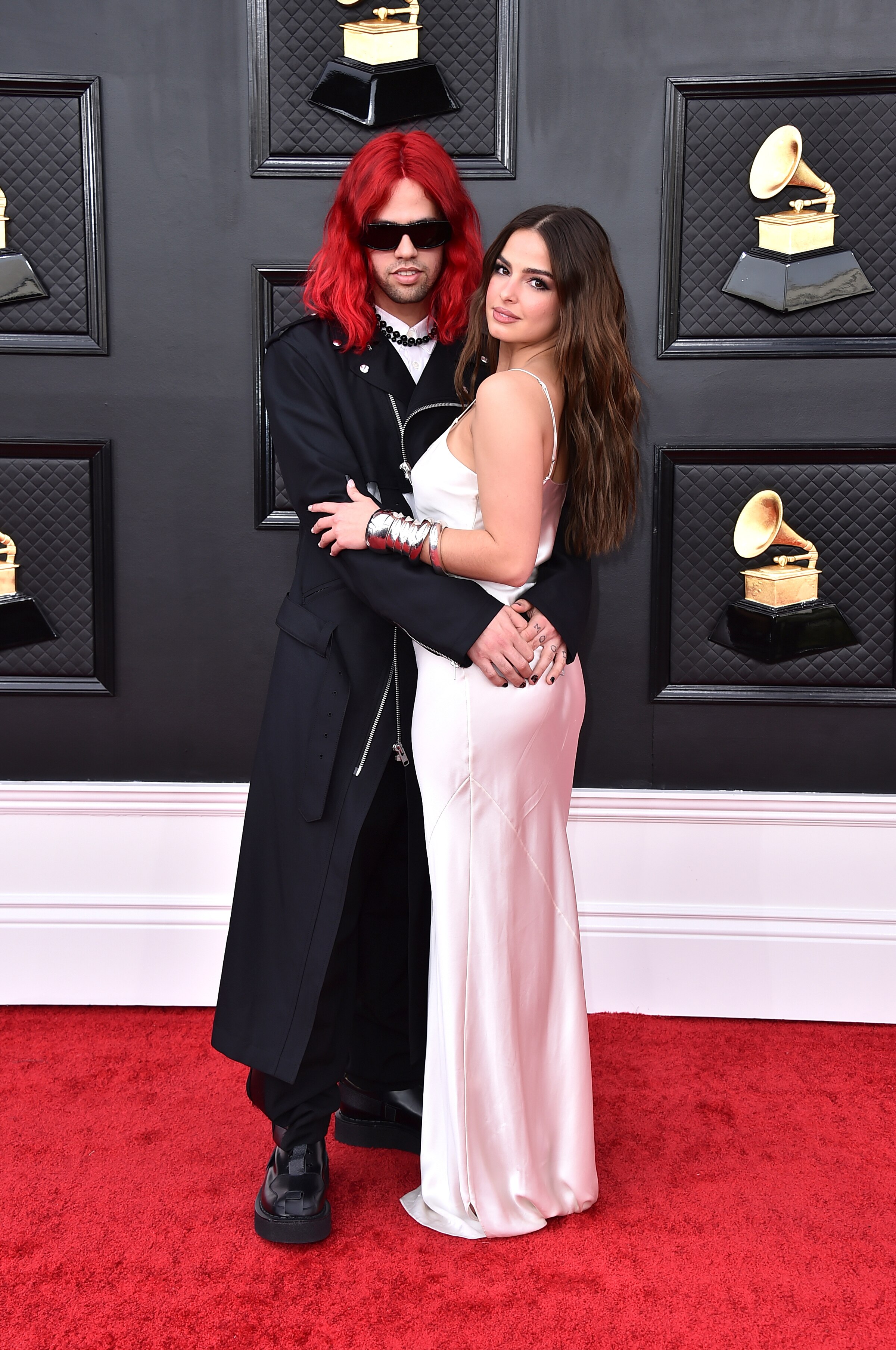 omer fedi and addison rae hug on the grammys red carpet. omer has bright red shoulder-length hair