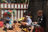 Dominica Tipiloura and Jewel Wheeler playing with kids.