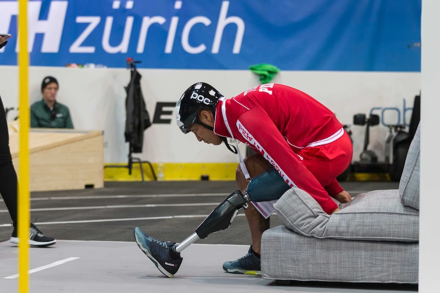 Team PUCP competitor gets off a couch during the Cybathlon