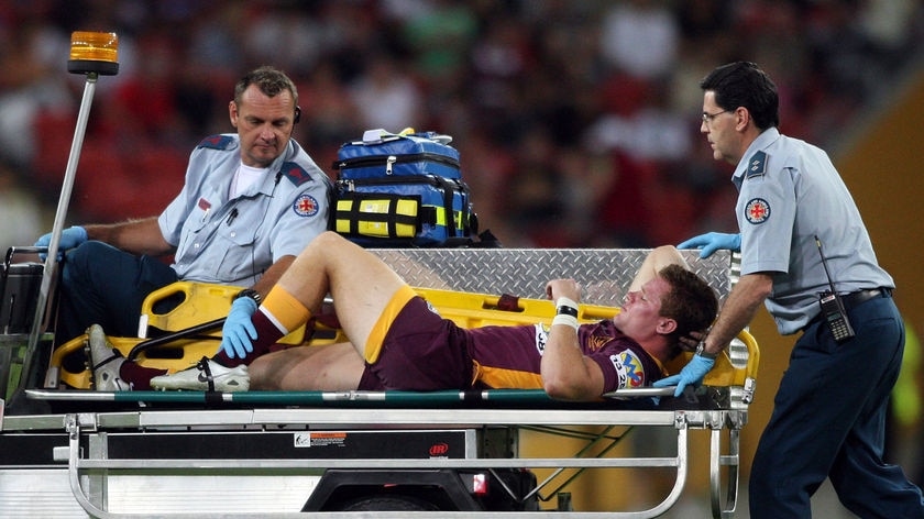 First to fall: Broncos' centre Steve Michaels was medi-cabbed from the field with a knee problem.