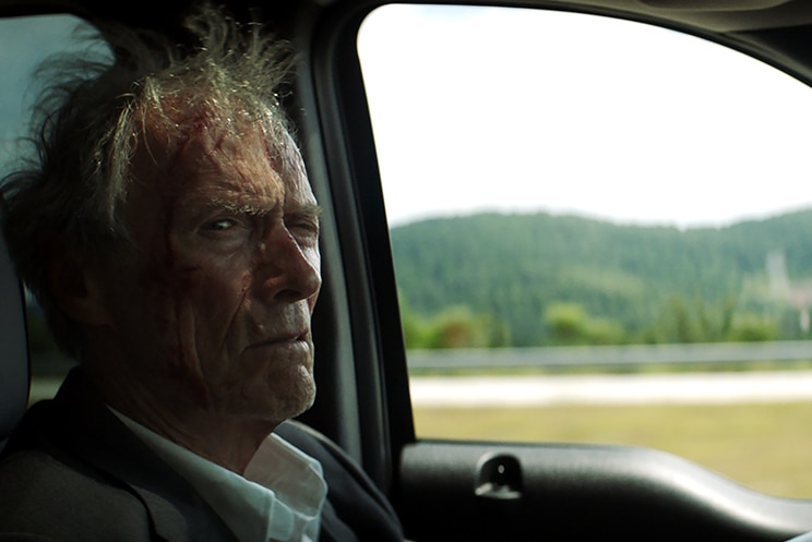 Colour photo of Clint Eastwood driving in 2019 film The Mule.