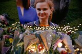 A picture of Jo Cox surrounded by flowers