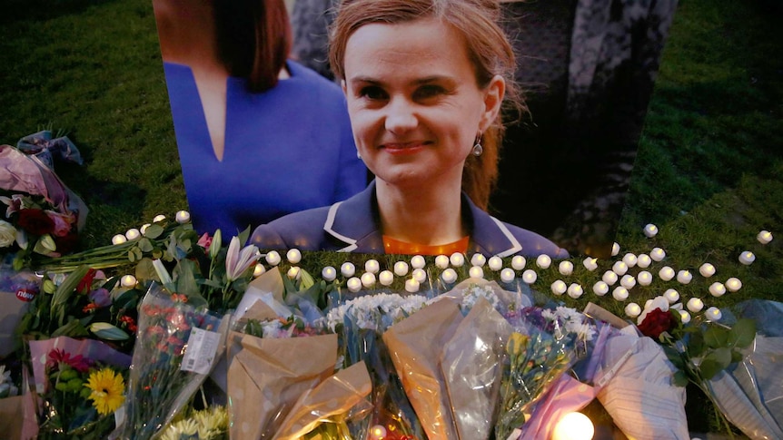 A picture of Jo Cox surrounded by flowers