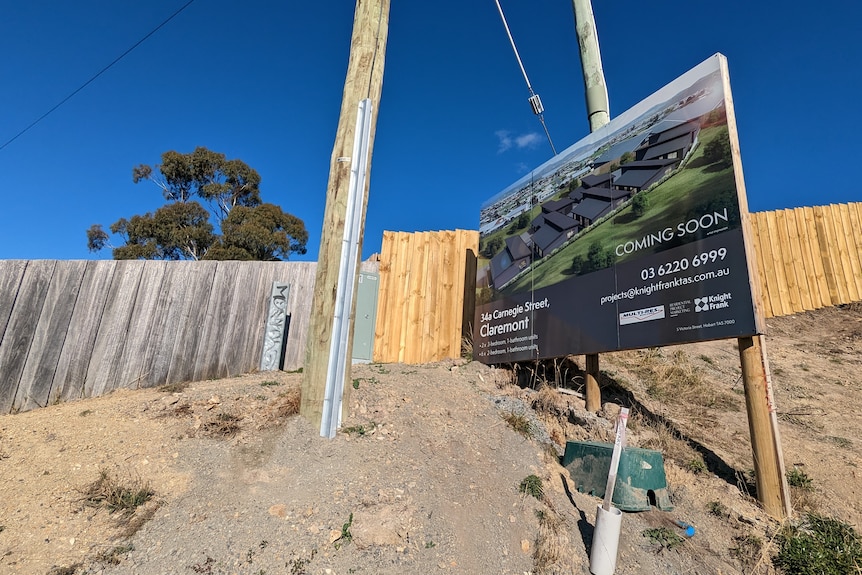  A sign advertises a housing complex on a building site