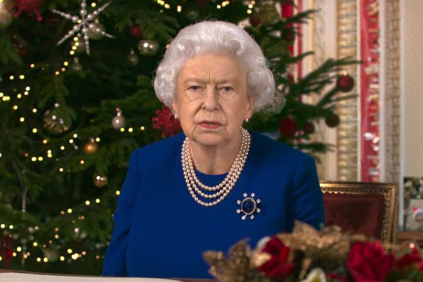 a deepfake image of Queen Elizabeth II sitting infront of a christmas tree