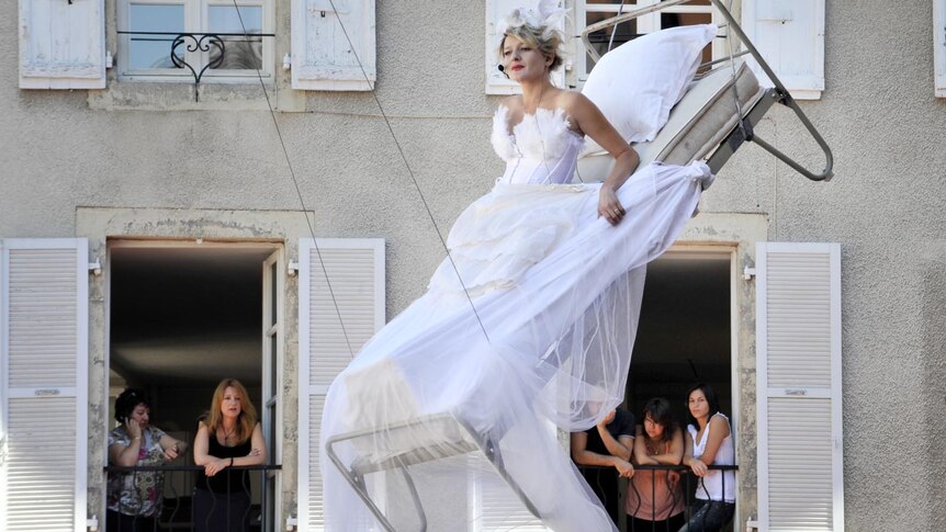 Bed suspended in front of the city hall of Aurillac during performance