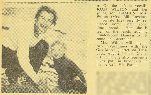 News clipping showing Joan and toddler Damien on a beach.