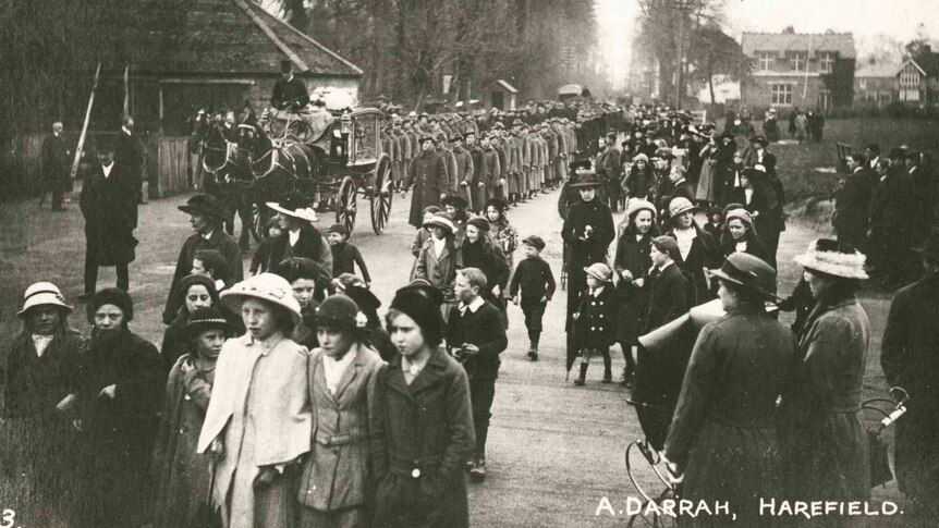 Soldiers parade down street in Harefield