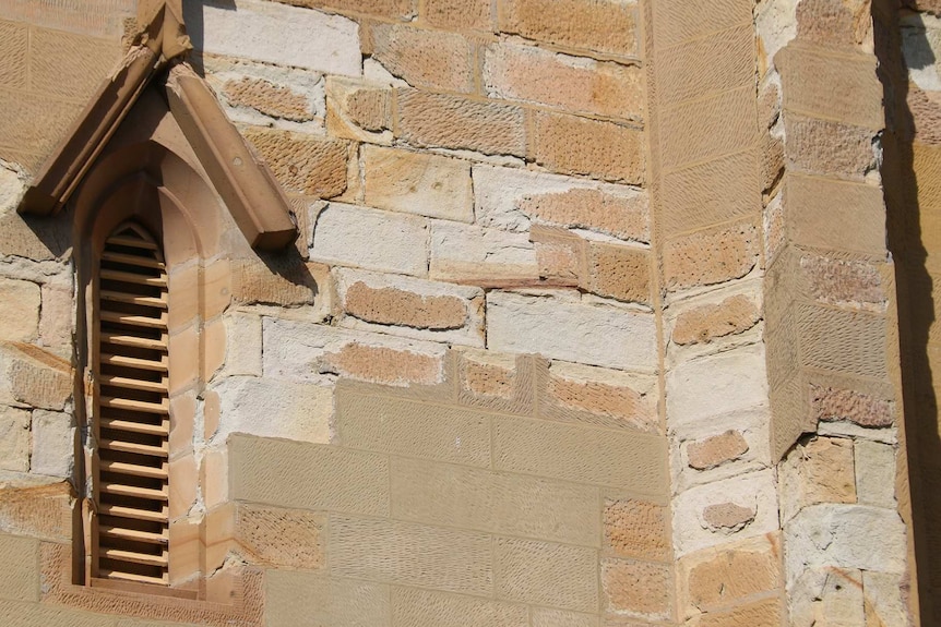 Close up showing disintegrating stonework, and repair attempts, at Holy Trinity Church, which was completed in 1848.